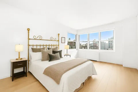 a bedroom with a large bed and a window