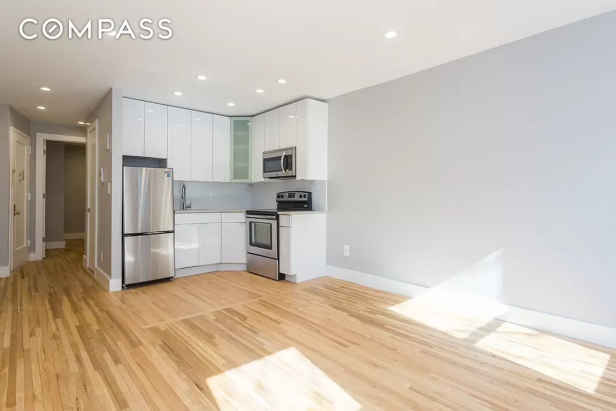 a kitchen with stainless steel appliances a refrigerator and a stove top oven