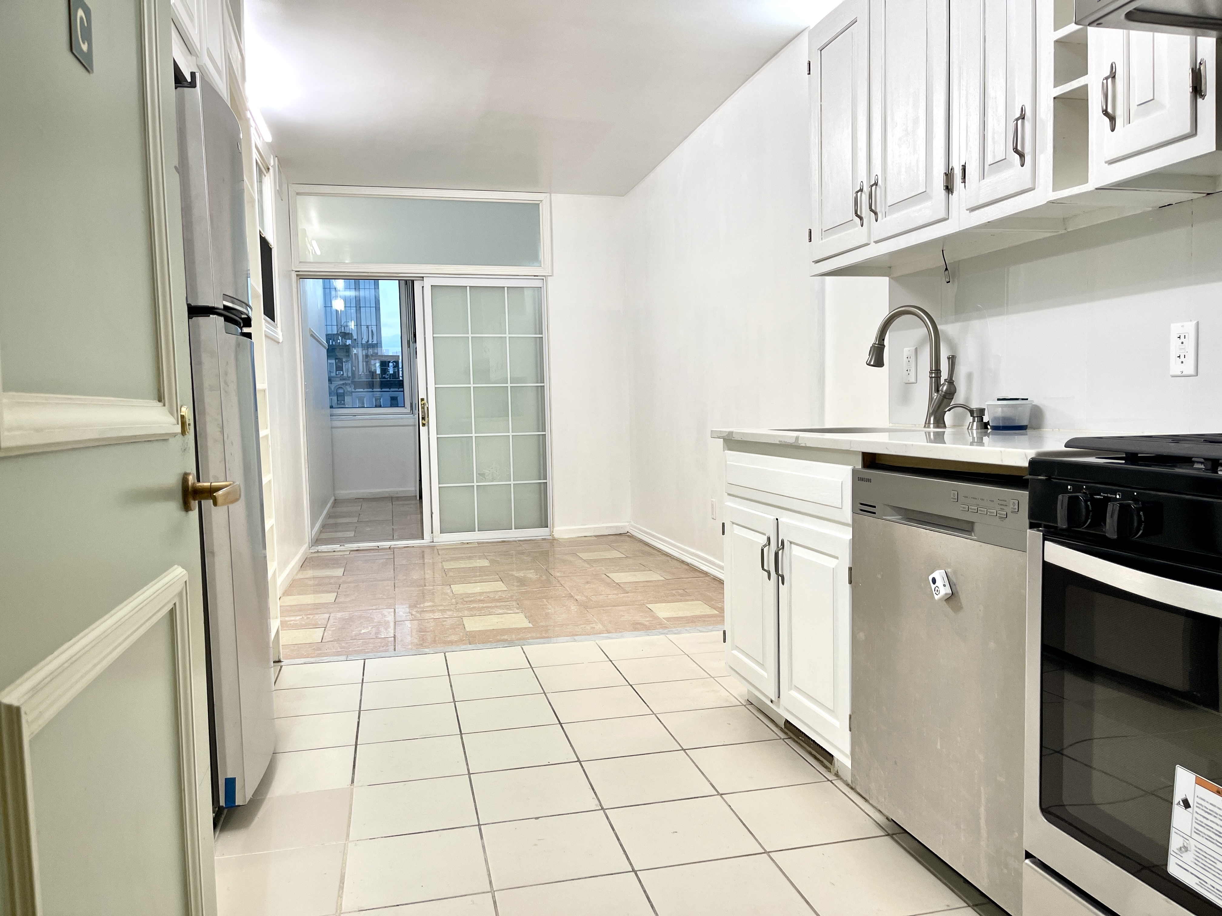 148A Madison Street, Unit 4 Manhattan, NY 10002 - Photo 2 of 13 a kitchen with a sink a stove and refrigerator