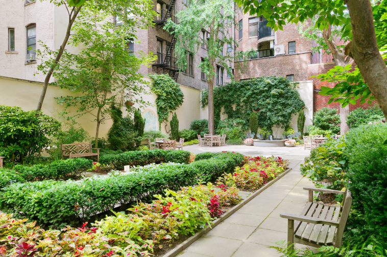 235 East 22nd Street, Unit 4T Manhattan, NY 10010 - Photo 8 of 15 front view of a house with a yard and potted plants
