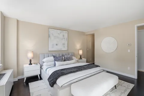 a bedroom with a bed and a lamp
