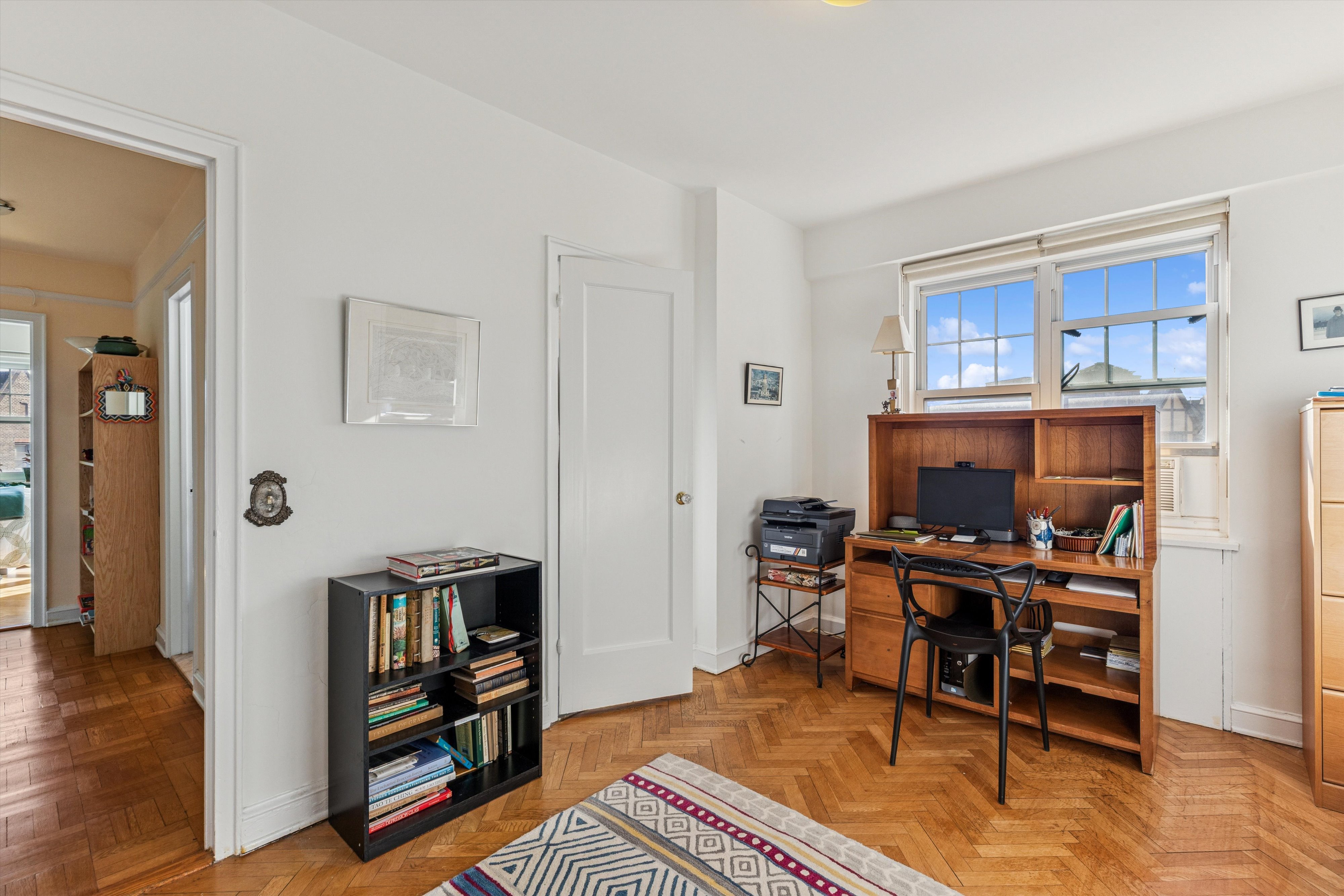 200 Cabrini Boulevard, Unit 86 Manhattan, NY 10033 - Photo 7 of 26 a workspace with furniture bookshelf and a window