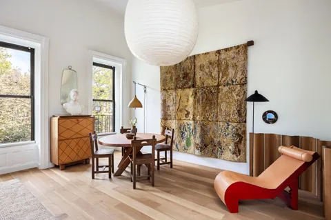 a dining room with furniture and wooden floor