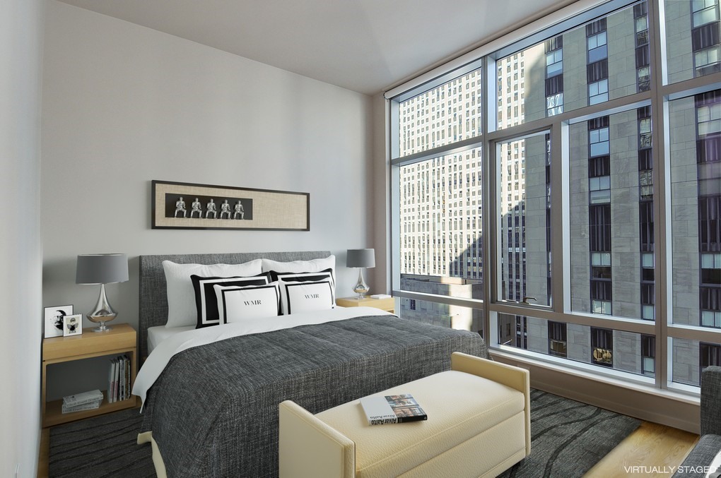 18 West 48th Street, Unit 23B Manhattan, NY 10036 - Photo 3 of 5 a living room with furniture and a window