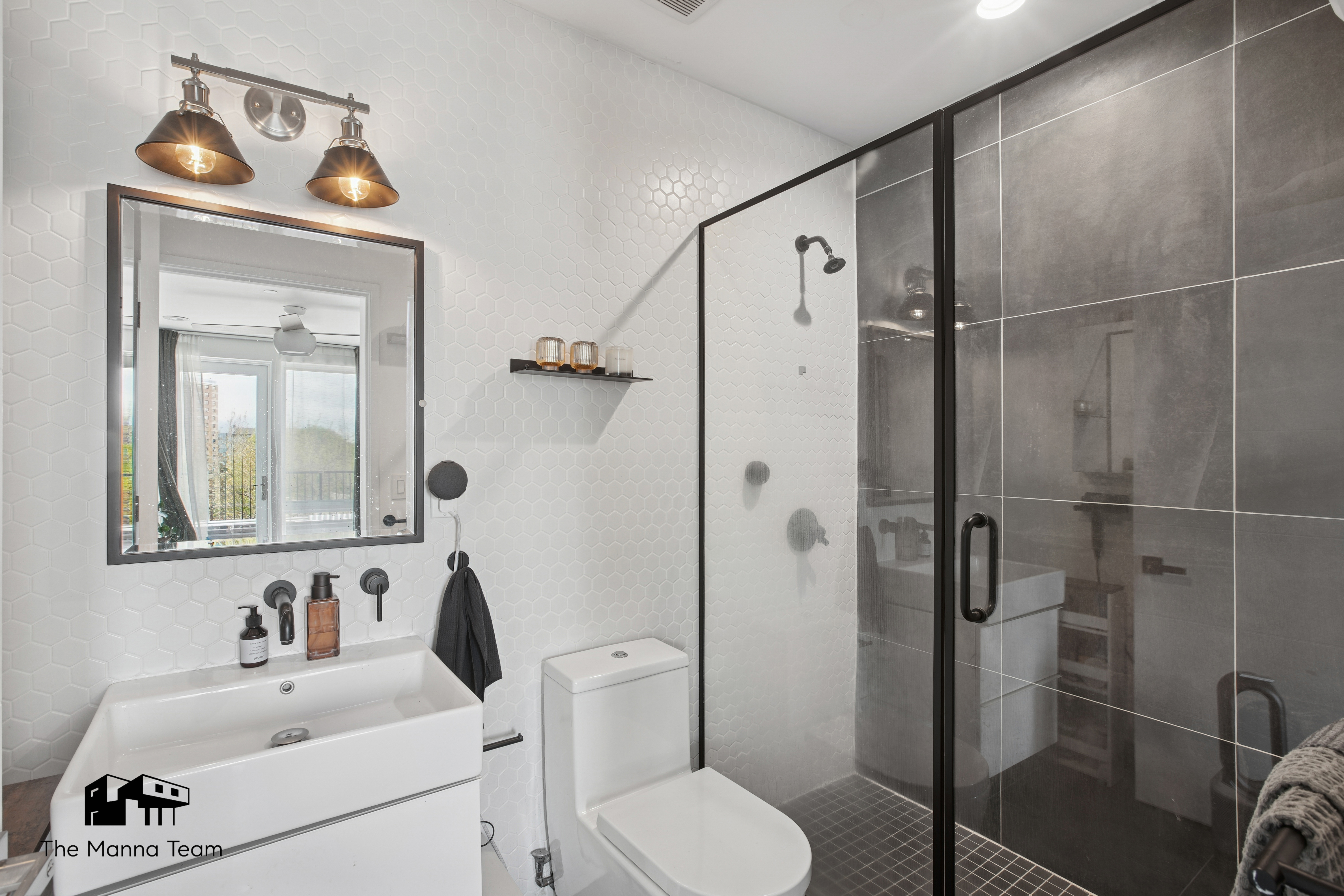 299 Van Buren Street, Unit 4C Brooklyn, NY 11221 - Photo 13 of 16 a bathroom with a toilet sink vanity and shower