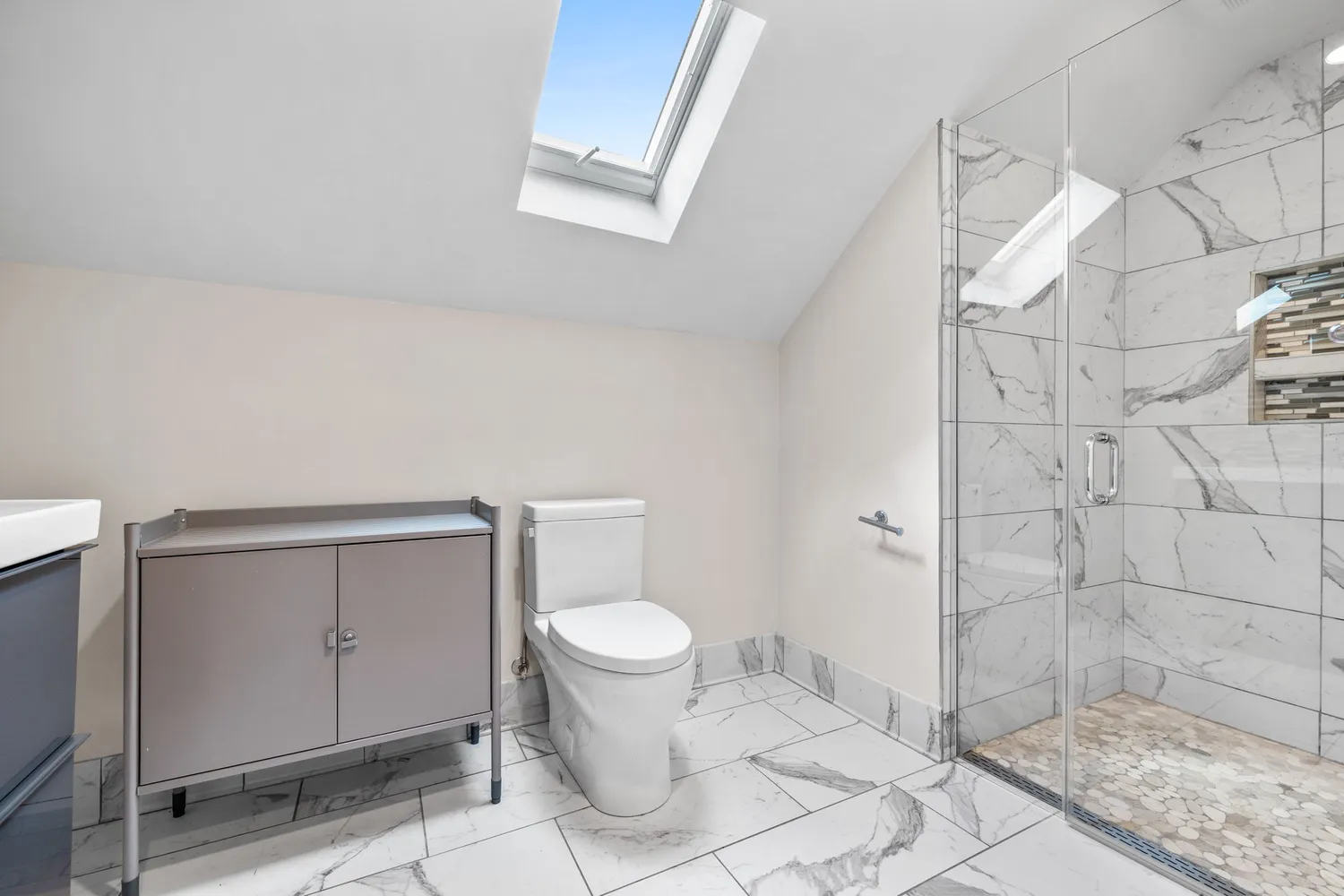 a bathroom with a toilet and a shower