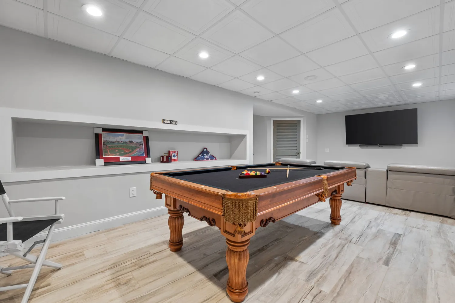 a bathroom with a sink a window and a flat screen tv