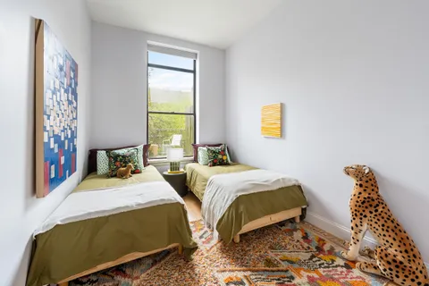 a bedroom with double bed and a window