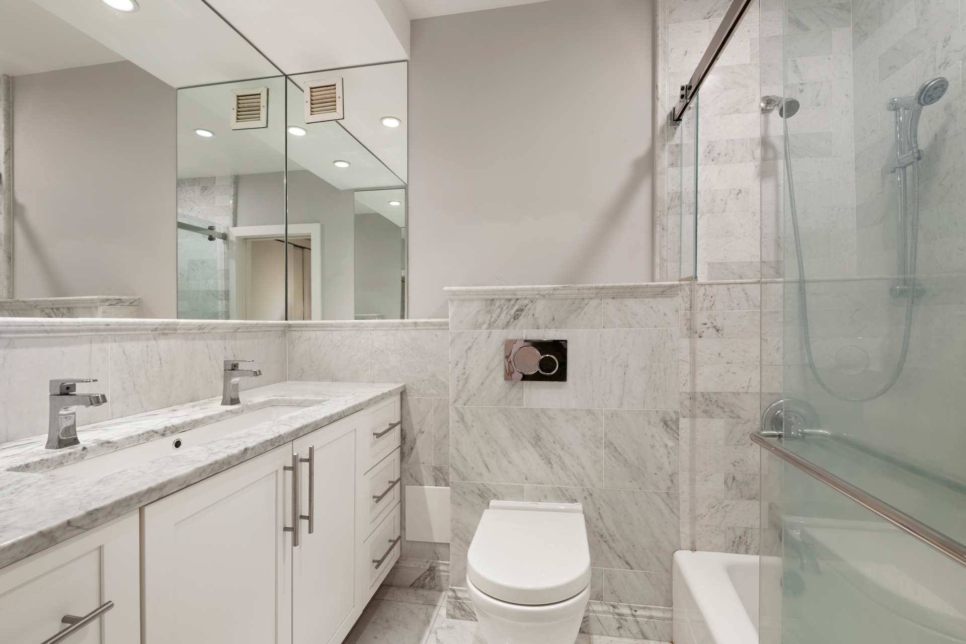 135 West 70th Street, Unit 4A Manhattan, NY 10023 - Photo 6 of 7 a bathroom with a granite countertop sink a toilet and a shower