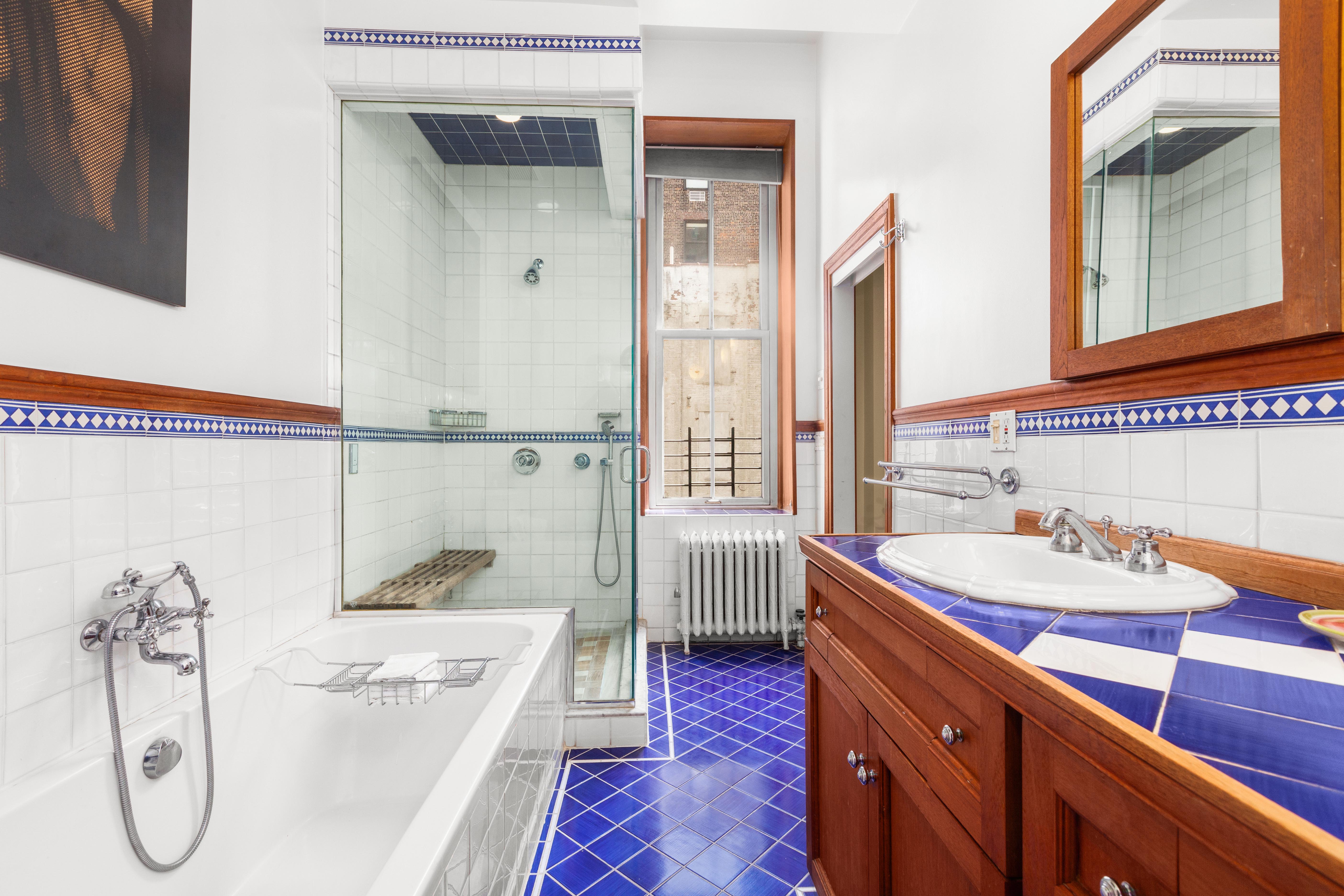 30 East 21st Street, Unit 6B Manhattan, NY 10010 - Photo 10 of 16 a bathroom with a granite countertop sink and a mirror
