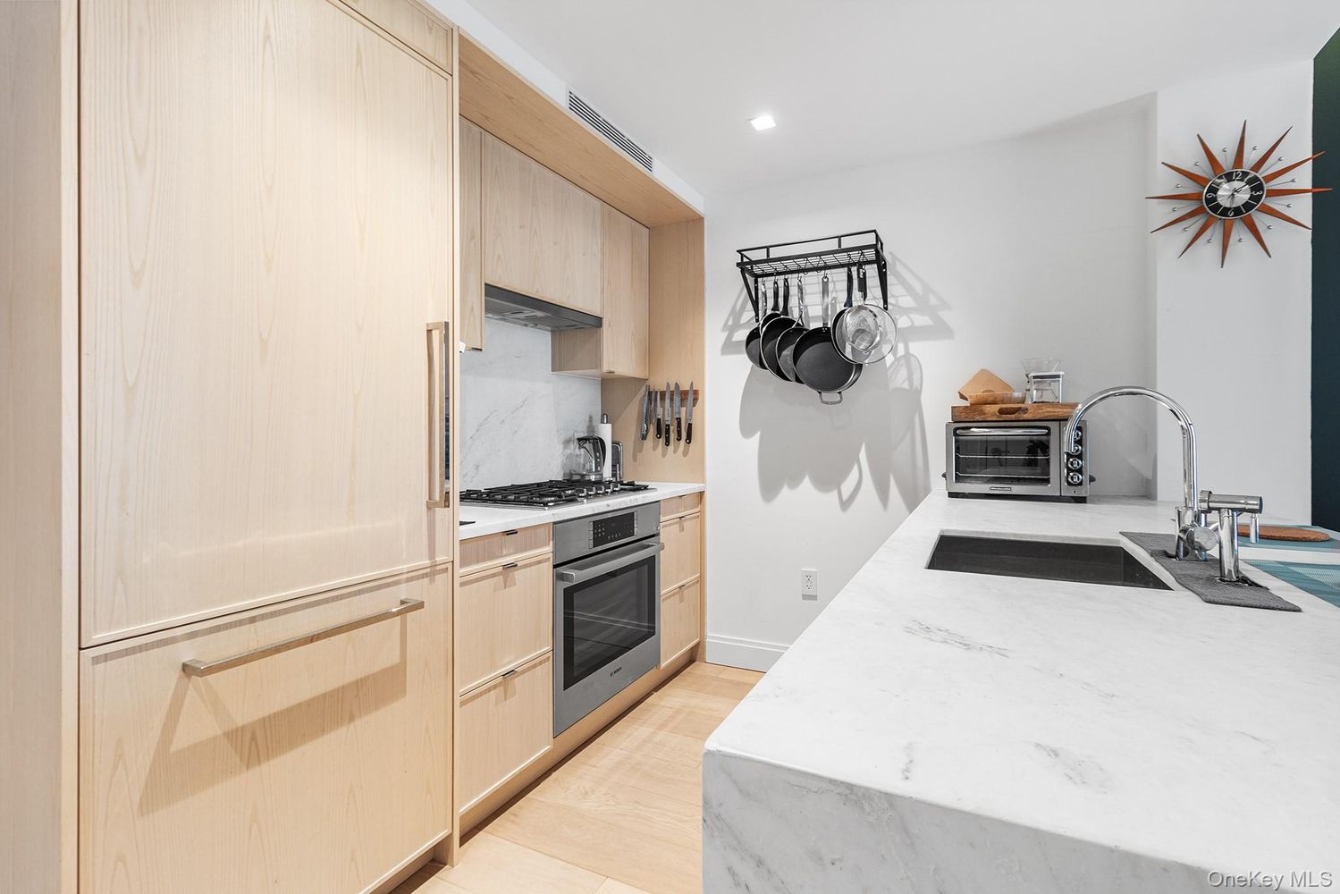 37-14 34th Street, Unit N3E Queens, NY 11101 - Photo 2 of 18 a kitchen with white cabinets and white appliances