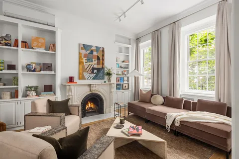 a living room with furniture or wooden floor and a large window