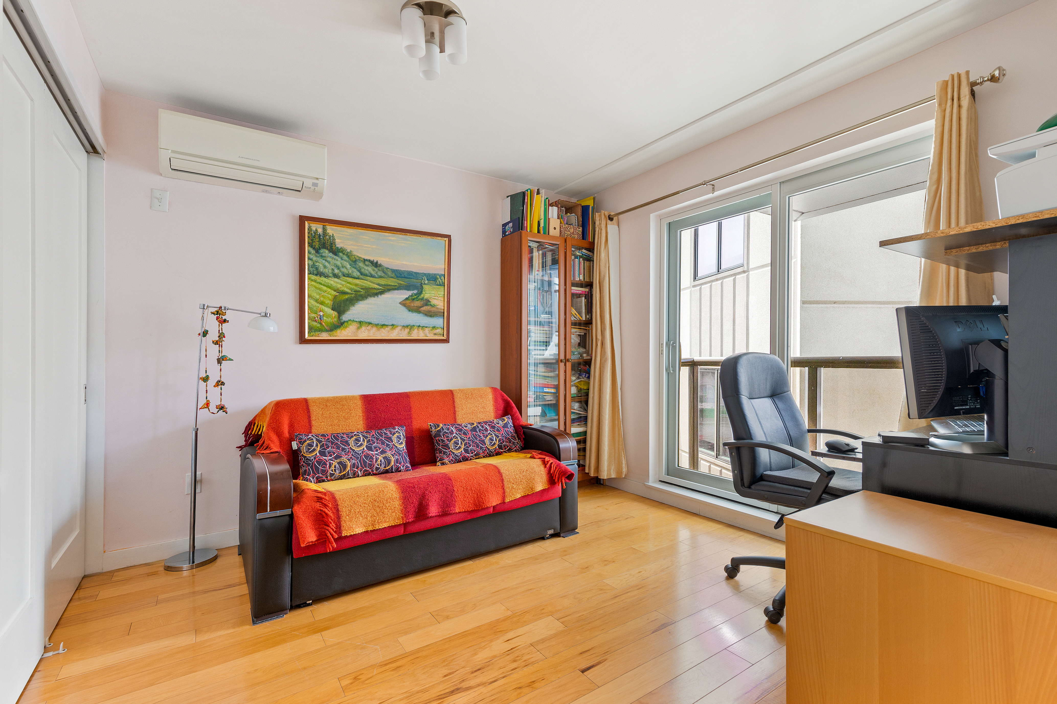 62 Brighton 2nd Place, Unit 4B Brooklyn, NY 11235 - Photo 7 of 12 a living room with furniture a flat screen tv and a window