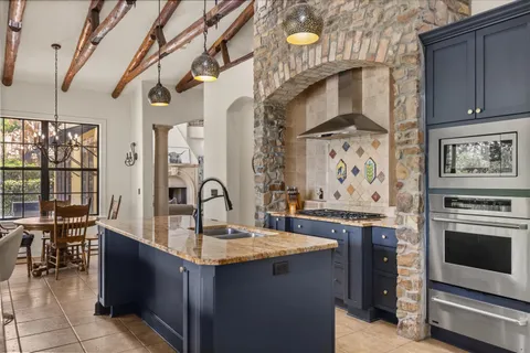 a kitchen with stainless steel appliances granite countertop a stove and a sink
