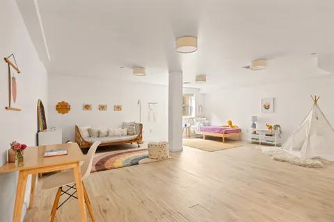 a bedroom with furniture and a wooden floor