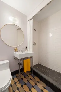 a bathroom with a sink toilet and a mirror