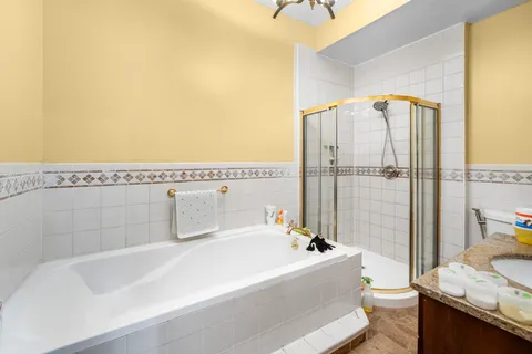 a spacious bathroom with a tub and shower
