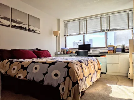 a bedroom with bed and window