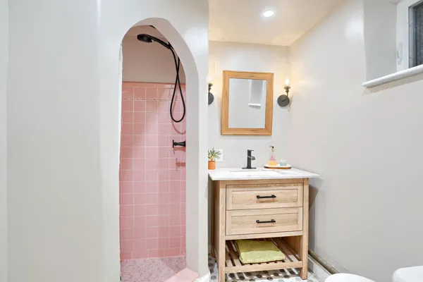 a bathroom with a sink a vanity and a mirror