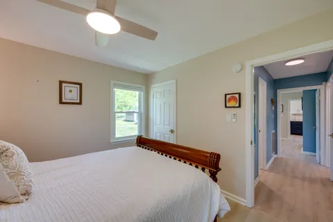 a bedroom with a bed and a lamp on dresser