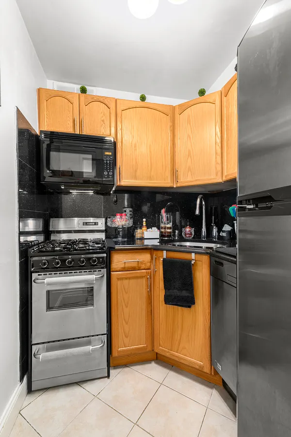 a kitchen with stainless steel appliances granite countertop a stove microwave and refrigerator