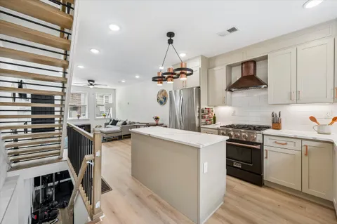 a kitchen with a sink stove and cabinets