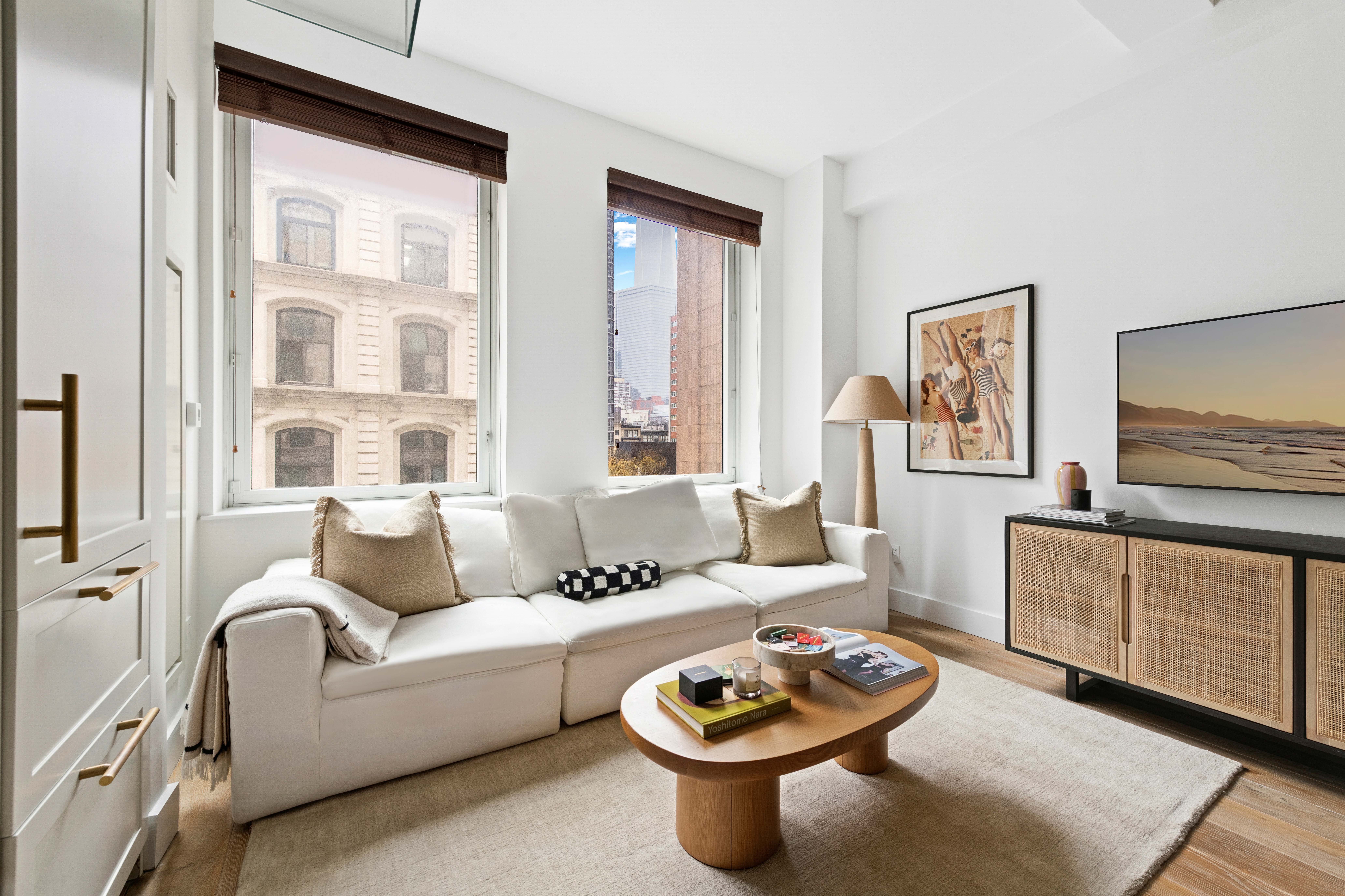 93 Worth Street, Unit 406 Manhattan, NY 10013 - Photo 2 of 11 a living room with furniture and a window