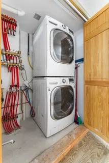 a view of a storage & utility room with dryer and washer