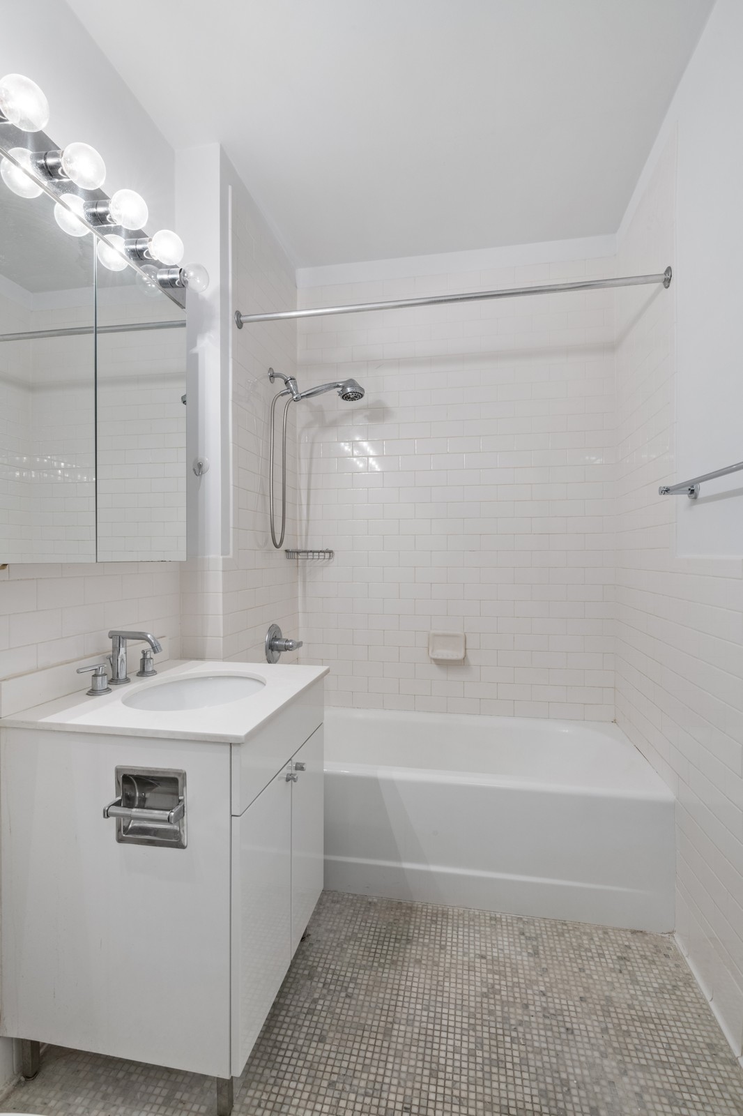 99 John Street, Unit 1711 Manhattan, NY 10038 - Photo 7 of 14 a bathroom with a sink a toilet and shower