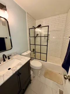 a bathroom with a sink toilet and shower