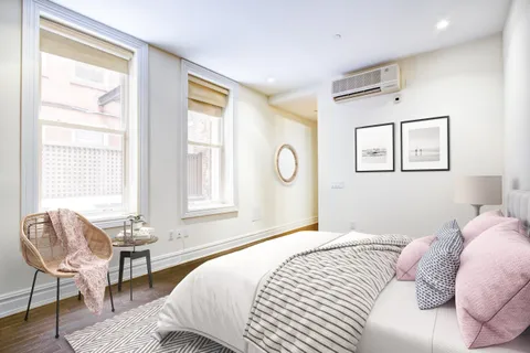 a bedroom with a bed and a chair