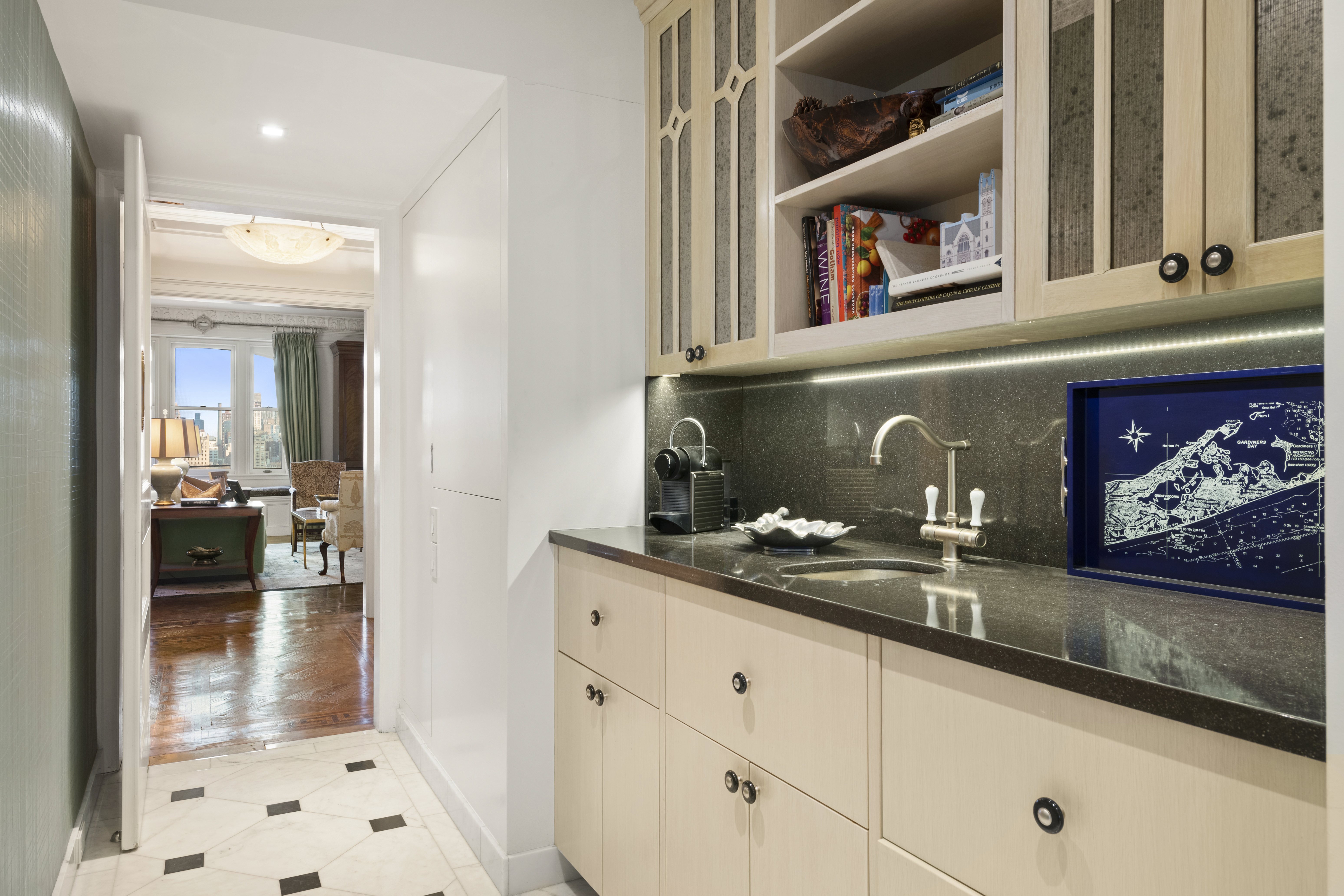 151 Central Park West, Unit 11NORTH Manhattan, NY 10023 - Photo 8 of 19 a hallway with cabinets and a wooden floor