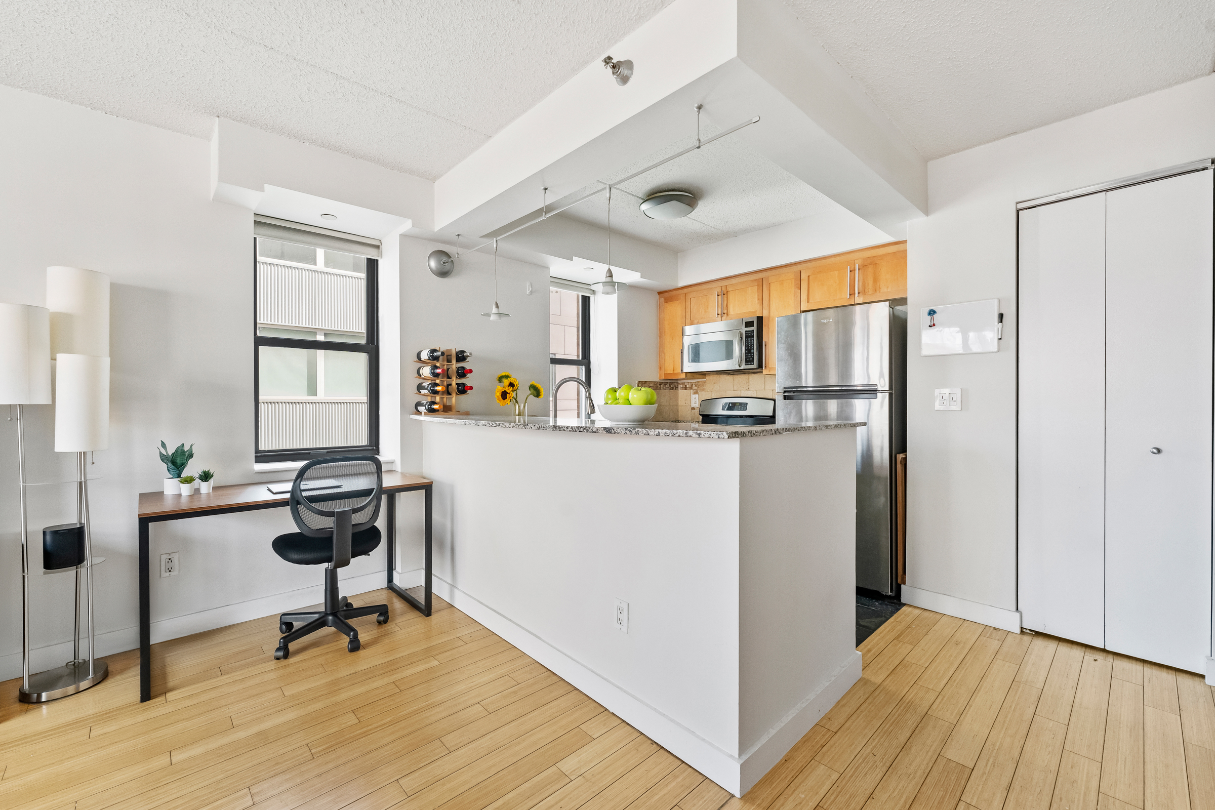 516 West 47th Street, Unit S6L Manhattan, NY 10036 - Photo 2 of 12 a view of a kitchen with dining table and chairs