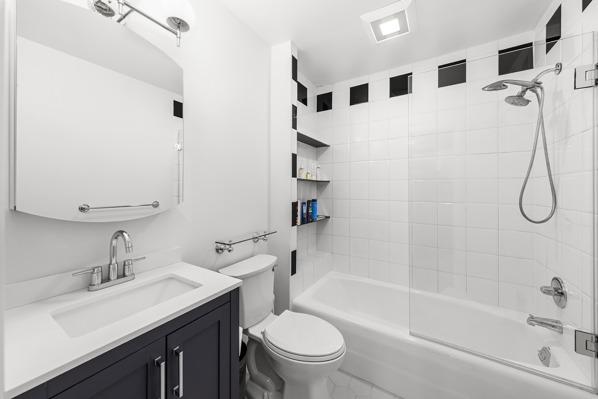 159 West 13th Street Manhattan, NY 10011 - Photo 19 of 36 a bathroom with a sink toilet vanity and shower