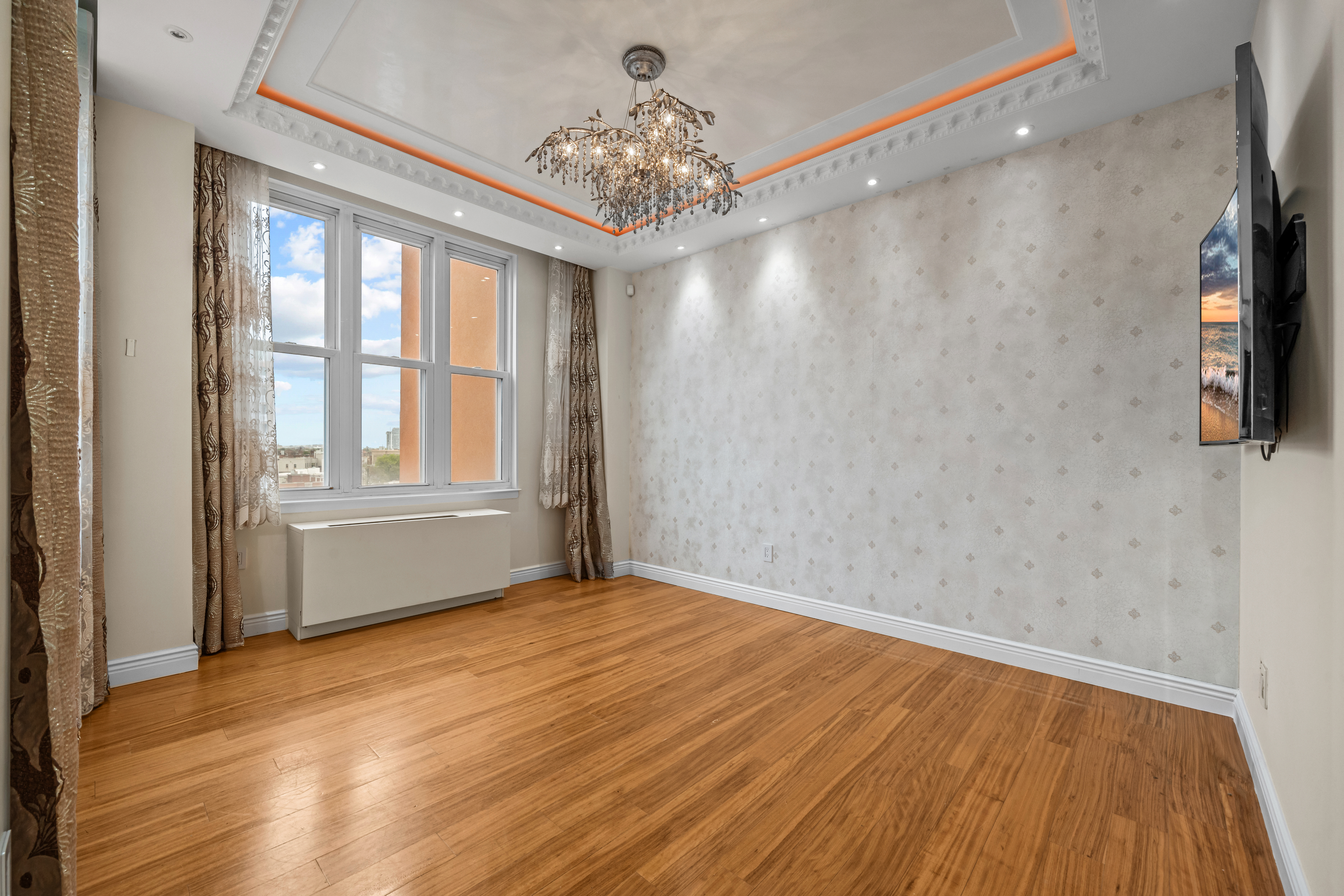 105 Oceana Drive East, Unit PH1D Brooklyn, NY 11235 - Photo 9 of 27 a view of empty room with wooden floor and fan