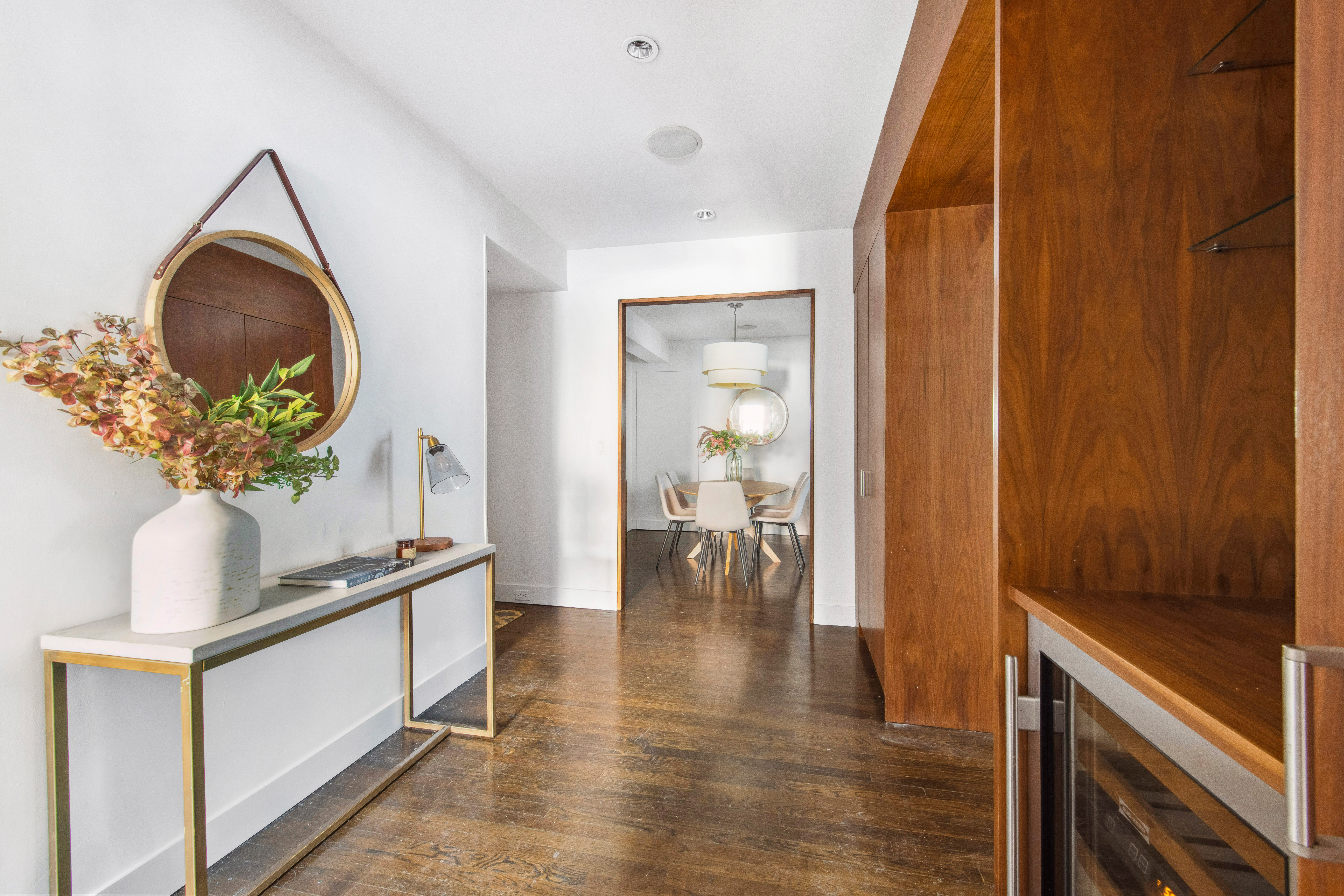 330 East 70th Street, Unit 5AB Manhattan, NY 10021 - Photo 3 of 13 a hallway with wooden floor and chandelier