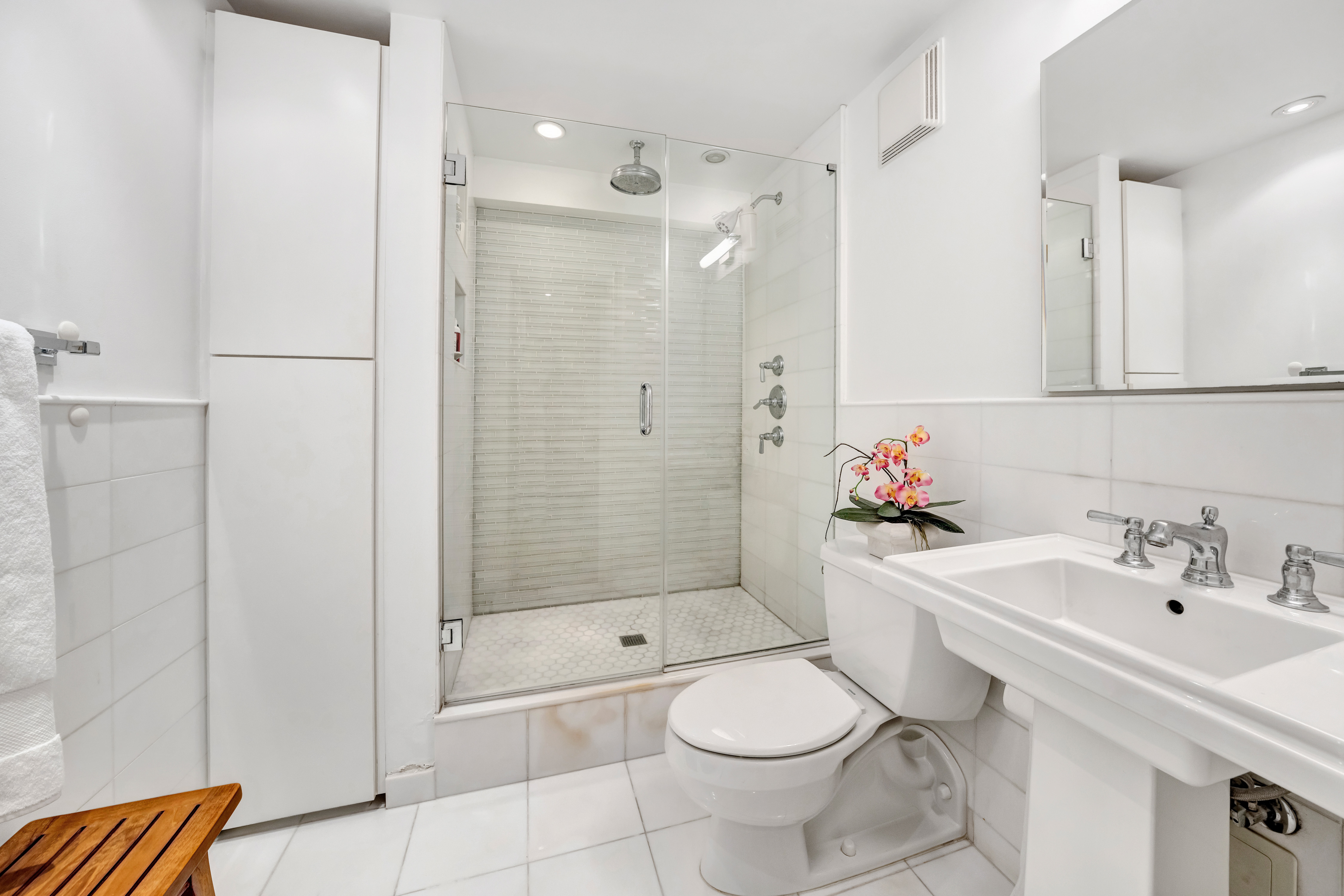 411 East 57th Street, Unit 11AB Manhattan, NY 10022 - Photo 9 of 17 a bathroom with a sink toilet and shower