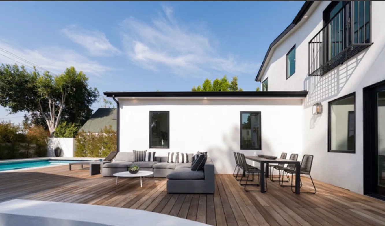 a view of balcony with furniture and wooden floor