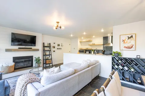a living room with furniture fireplace and flat screen tv