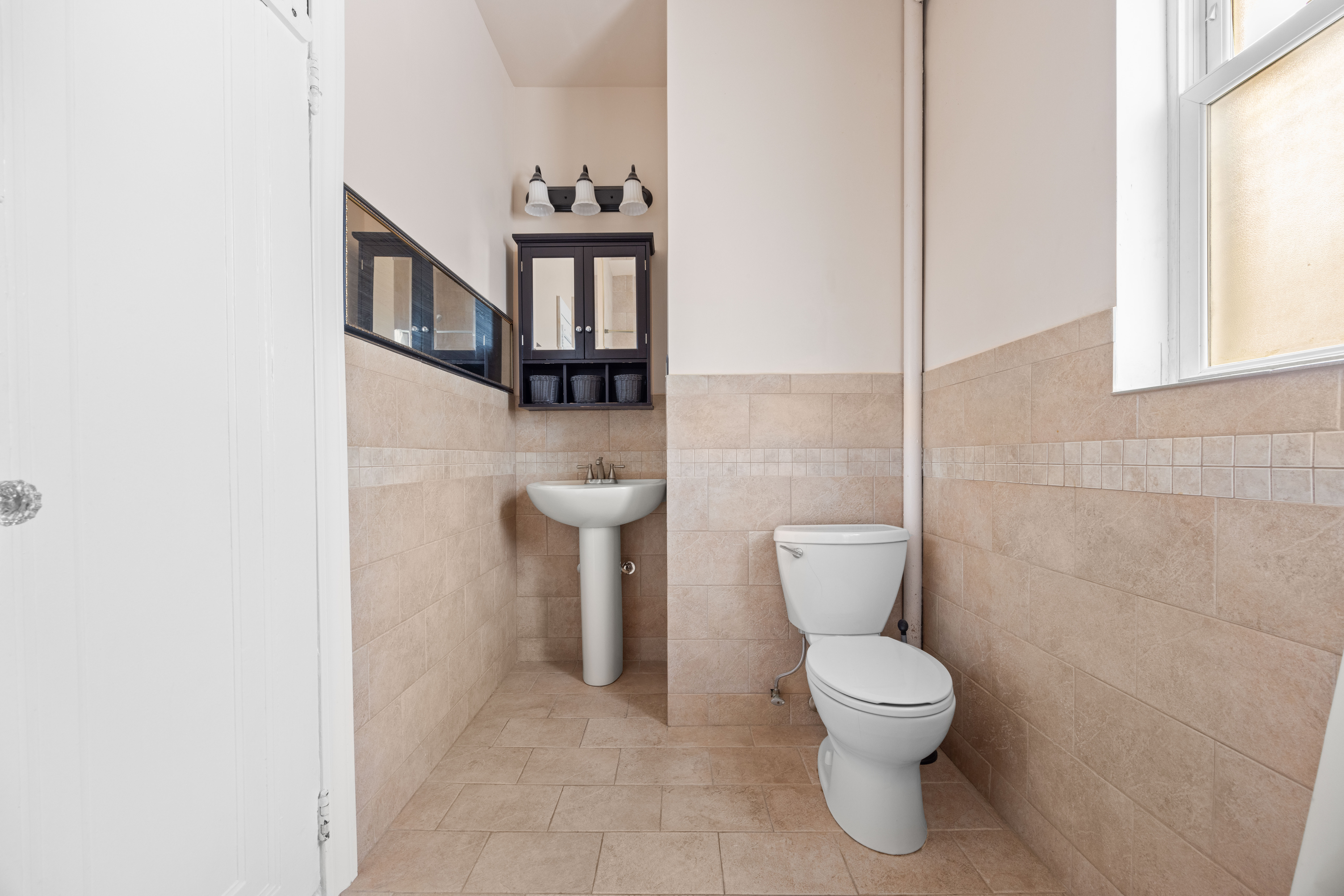 3712 Oceanic Avenue, Unit 2 Brooklyn, NY 11224 - Photo 8 of 14 a bathroom with a toilet and a sink