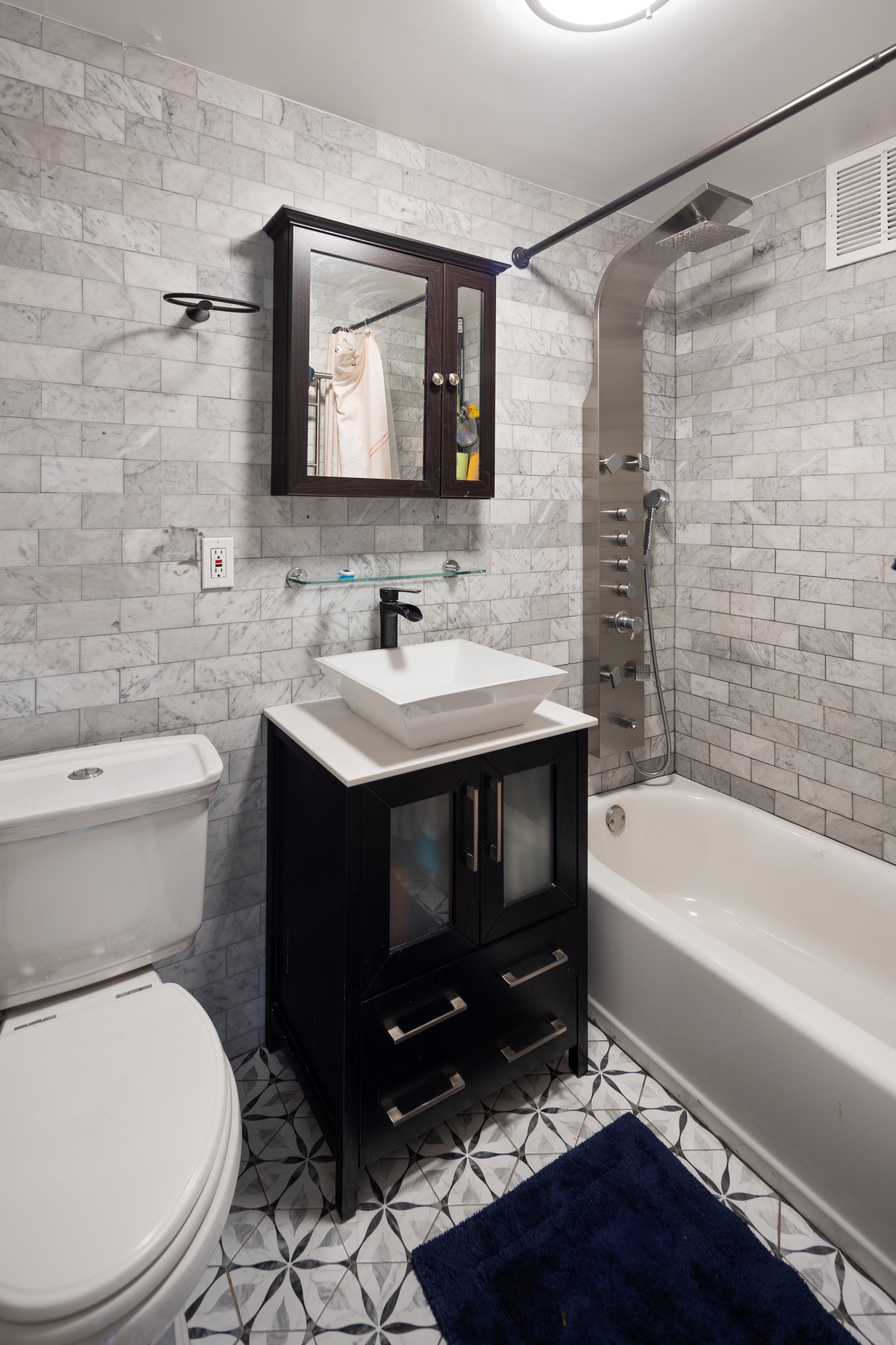 210 Clinton Avenue, Unit 4B Brooklyn, NY 11205 - Photo 5 of 8 a bathroom with a sink toilet a mirror and bathtub