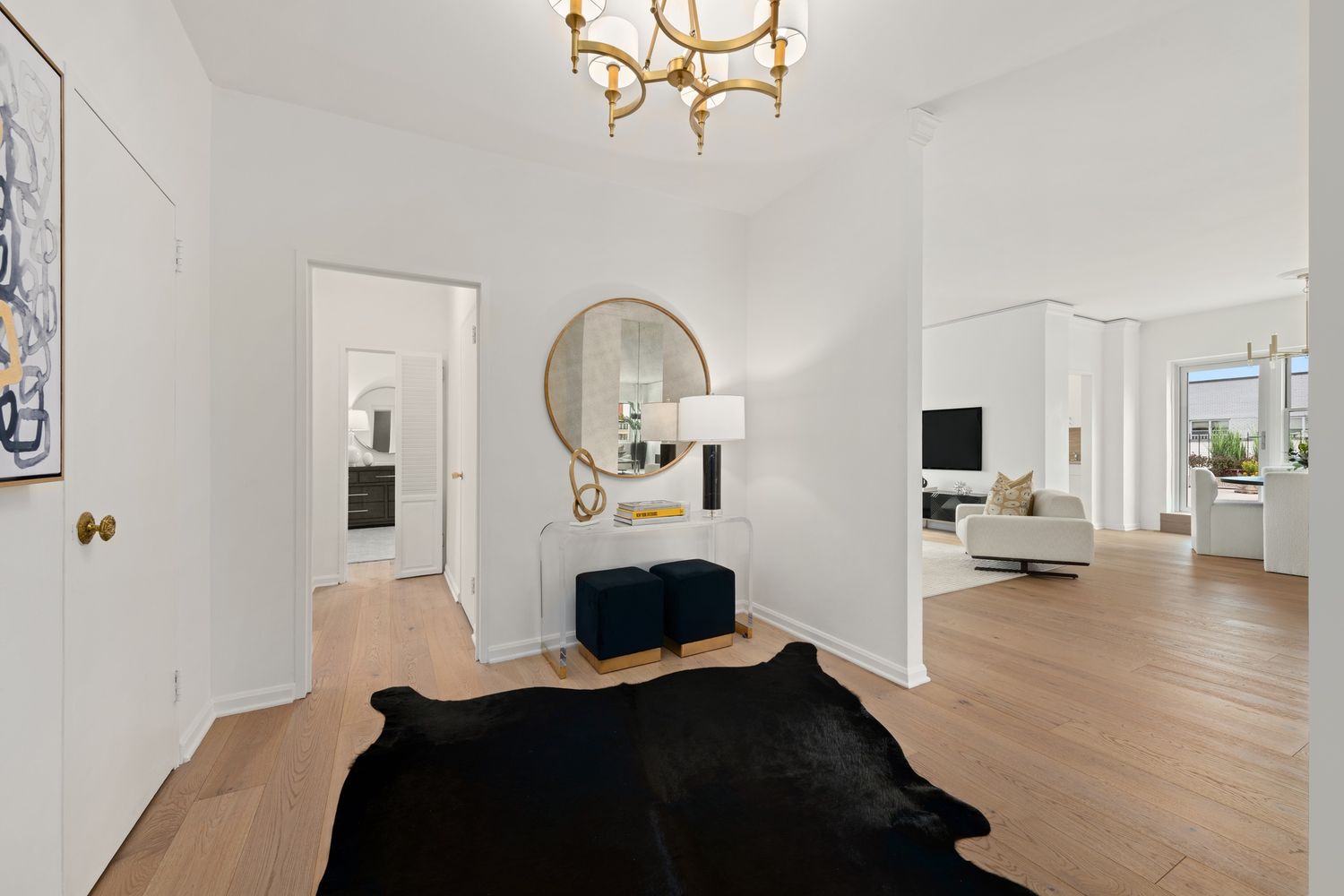 a view of living room with furniture and a mirror