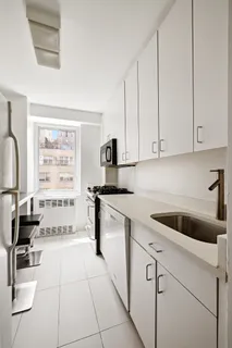 a kitchen with a cabinets and white appliances