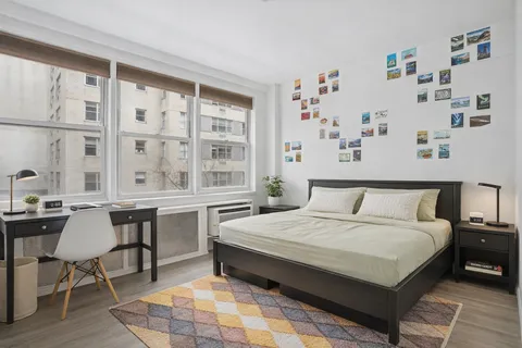 a large bedroom with a bed and a table in it