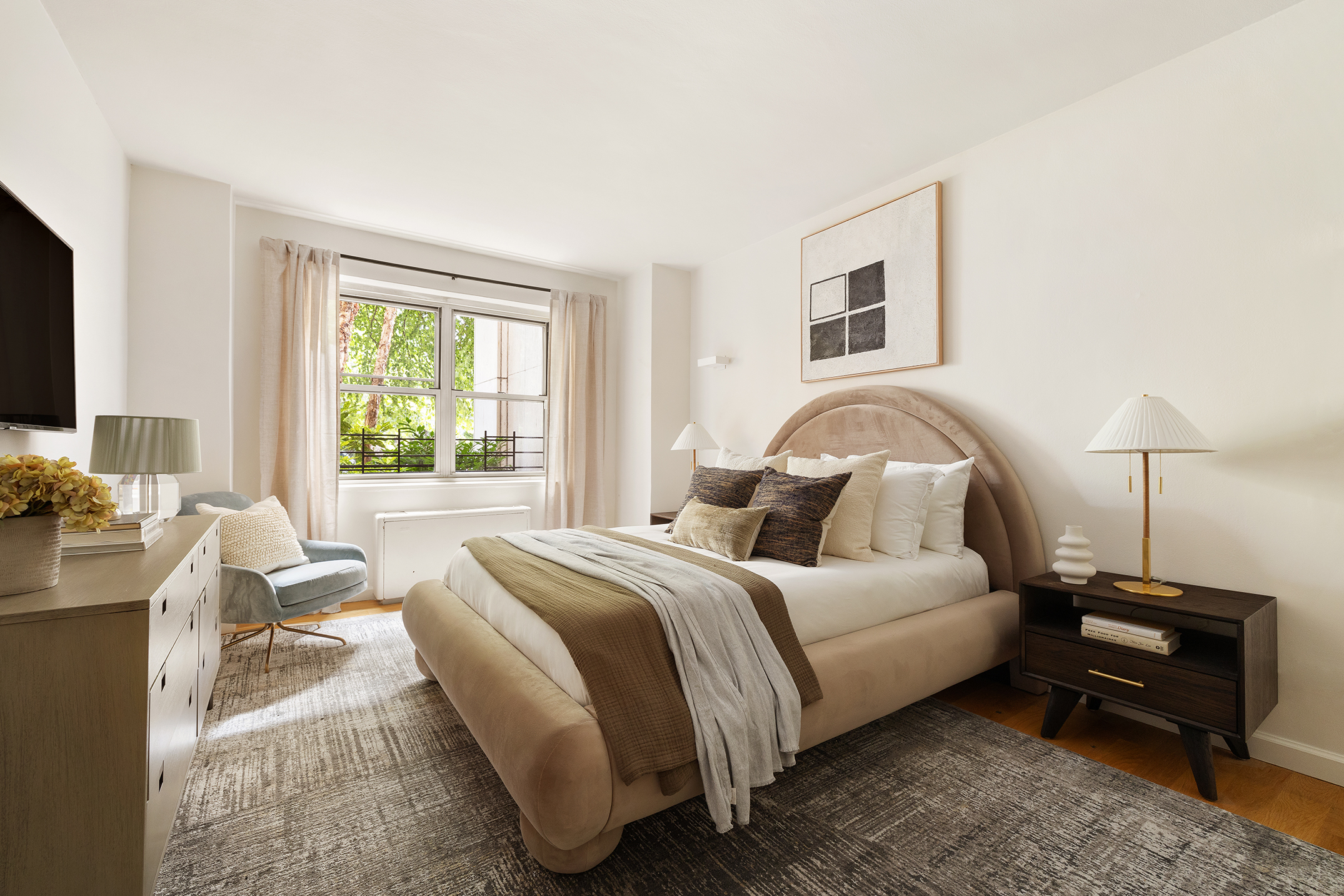 180 East End Avenue, Unit 1C Manhattan, NY 10128 - Photo 9 of 19 a bedroom with a bed and a flat screen tv