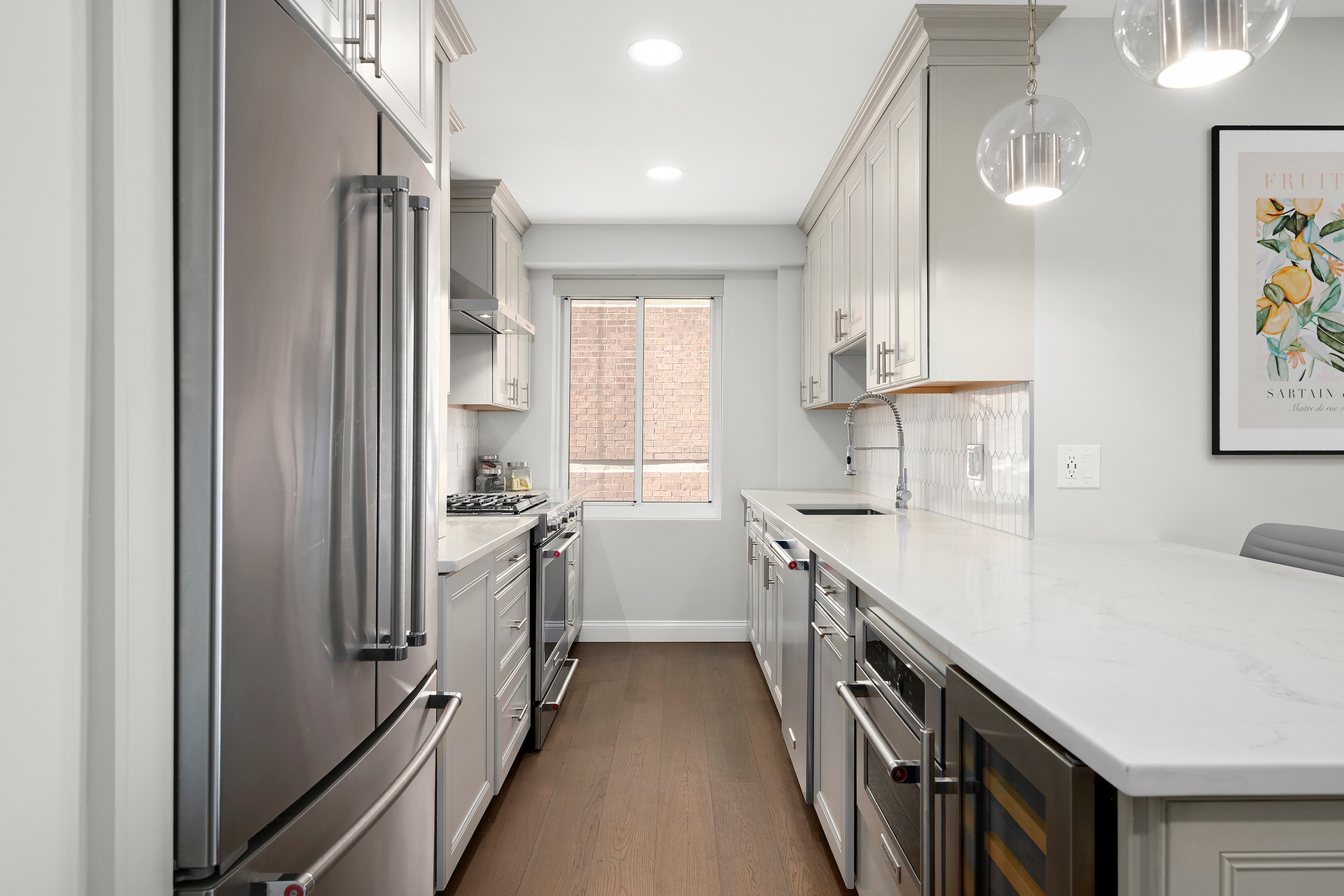 420 East 58th Street, Unit 14B Manhattan, NY 10022 - Photo 2 of 10 a kitchen with a sink stove and refrigerator