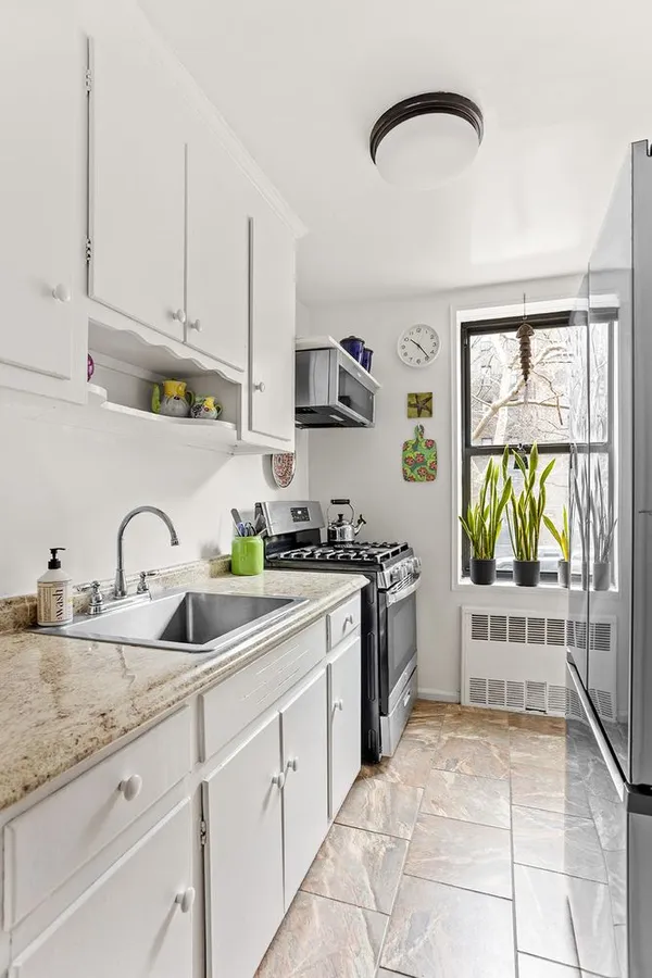 a kitchen with stainless steel appliances granite countertop a sink and a stove