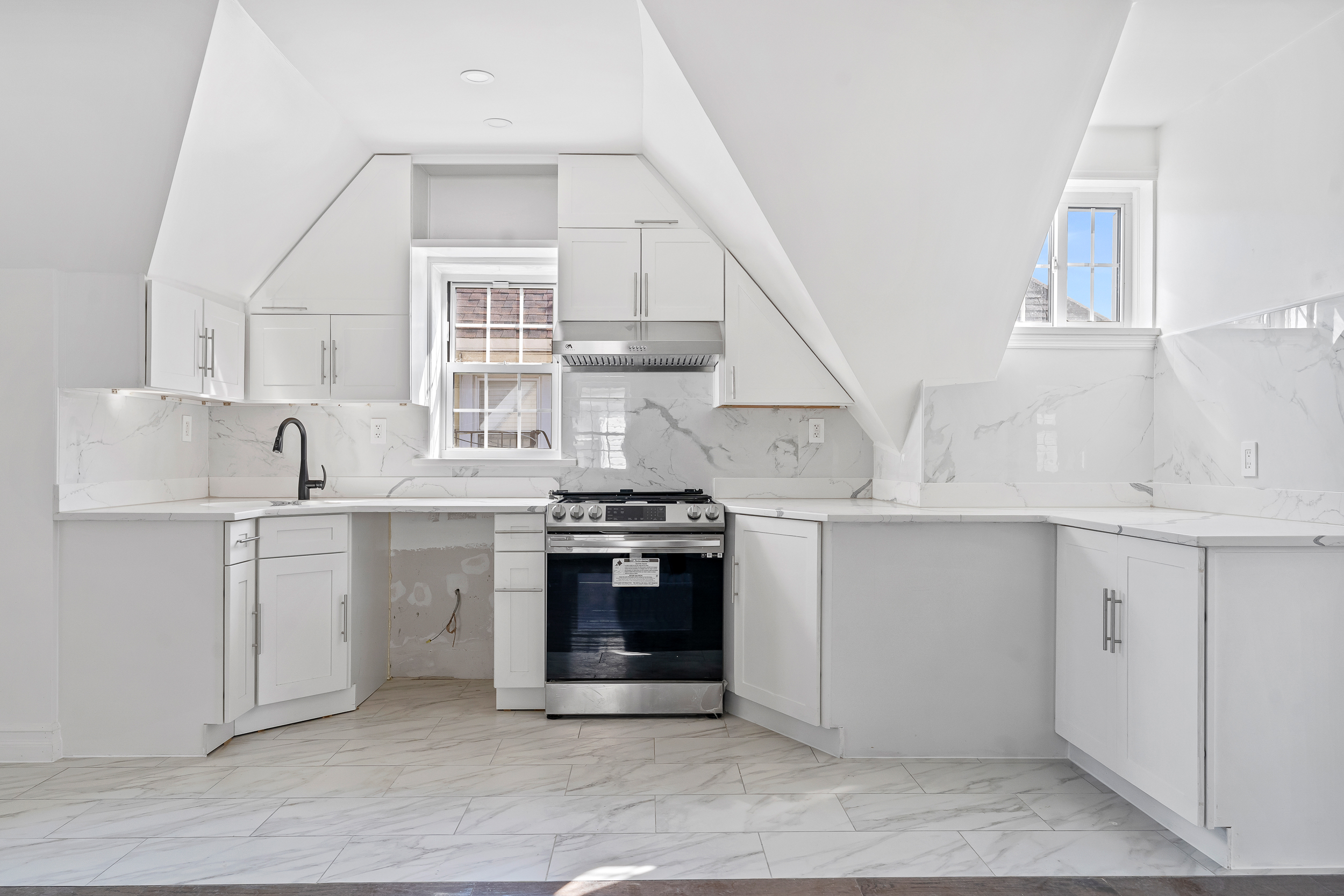 65 Bay 23rd Street, Unit 3 Brooklyn, NY 11214 - Photo 5 of 11 a kitchen with cabinets appliances and a window