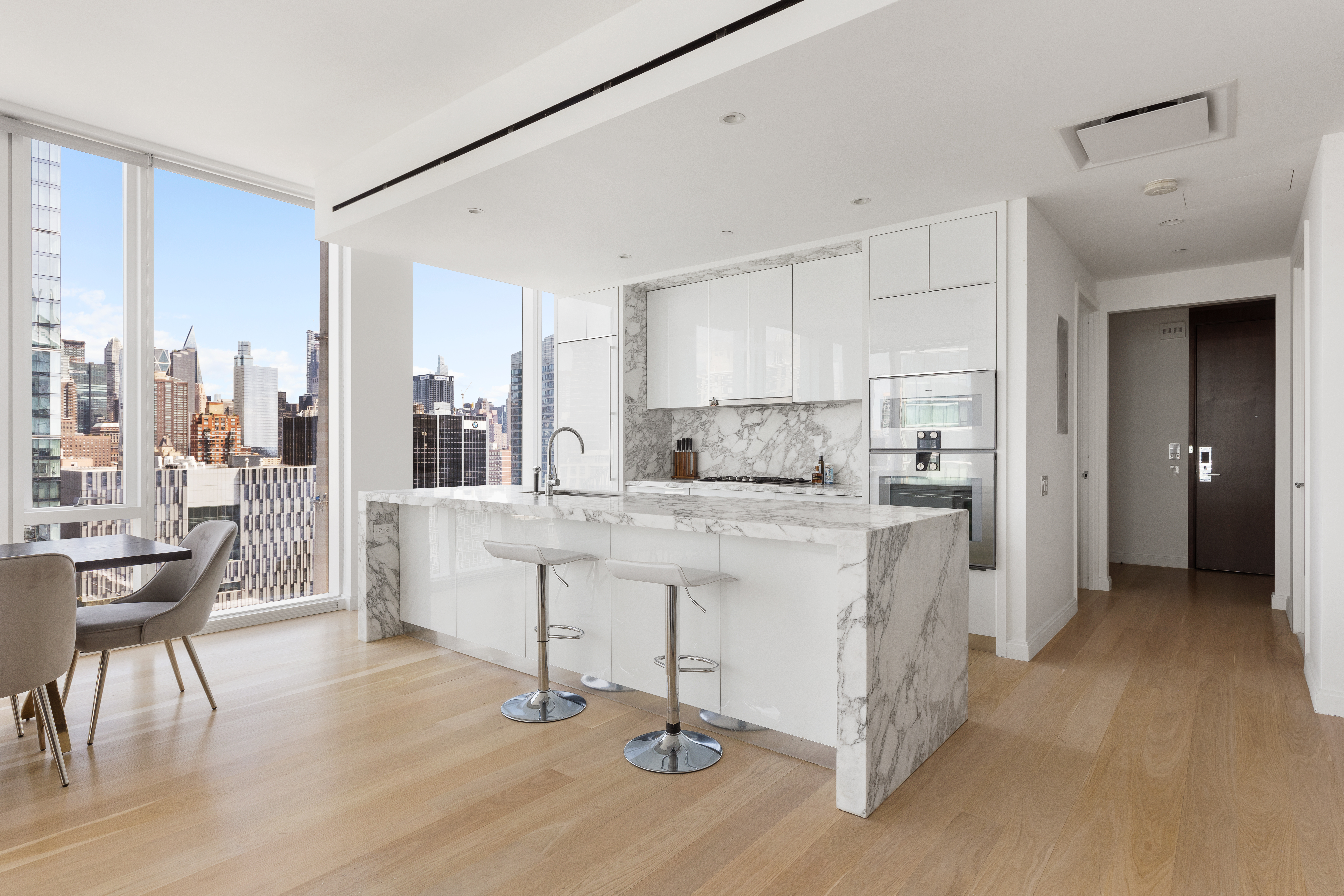 10 Riverside Boulevard, Unit 27D Manhattan, NY 10069 - Photo 2 of 21 a kitchen with kitchen island granite countertop lots of counter top space and refrigerator