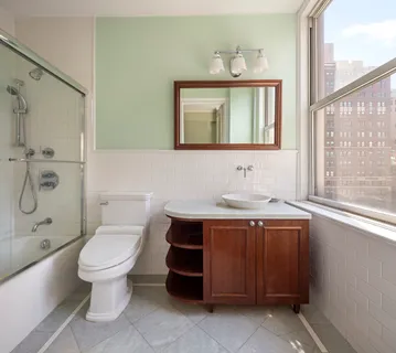a bathroom with a sink a toilet and mirror